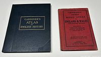 Both atlases shown together; one large dark blue Gardiner's Atlas and a smaller red Geographia Pocket Road Atlas.