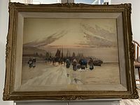 Full view of the framed watercolour painting showing coastal scene with group of people and boats under a cloudy sky at sunrise or sunset, set in ornate gold-toned antique frame.