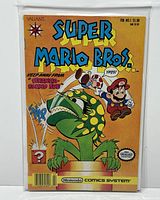 Full front cover of the Super Mario Bros. #1 comic with Mario and Piranha Plant on orange background, showing condition and bagged presentation.