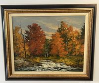 Overall view of framed painting depicting autumn waterfall landscape