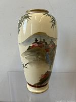 Front and side view of vase showing detailed painted landscape and bamboo design.
