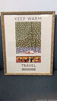 Front view of framed 'Keep Warm' London Underground poster showing full artwork, signature, and frame.