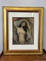 Framed Edvard Munch Madonna art print shown from a slight angle highlighting the gold frame and matting.
