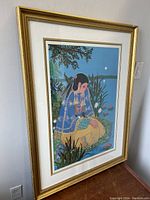 Full view of framed print showing Native American woman by water in traditional attire under moonlight.
