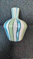 Front view of colorful latticino patterned Murano squat vase with bulbous body and narrow neck