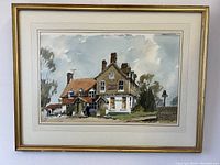 Frontal view of the framed watercolour painting showing the old English pub.