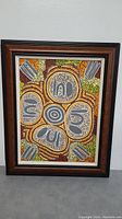 Full framed painting showing Indigenous style dot painting with colorful circular and abstract patterns.