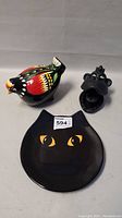 Photo showing all three animal items: the colorful chicken, black monkey, and black cat plate