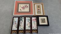 Photo showing all four Chinese related art pieces, including framed coin art with red matting, four-panel women-themed painted screen, and two smaller framed art pieces.