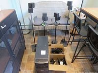 Wide view showing Acoustimass subwoofer, six cube speakers, four stands and two boxes of cables