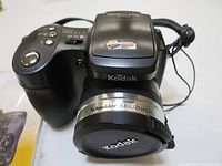 Front view showing Kodak lens with Schneider-Kreuznach branding and camera body with buttons.