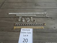 Photo shows the entire lot arranged on a wooden surface including choker, bracelets and earrings as described.
