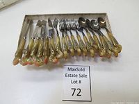 Full set of vintage cutlery in original box including forks, spoons, and cutting utensils with decorative handles.