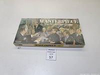 Closed vintage Masterpiece The Art Auction Game box with illustrated cover art of an auction scene.