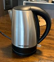 Front view of Black & Decker electric kettle showing stainless steel body and black handle with brand logo.