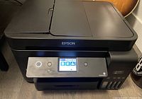 Front view of matte black Epson EcoTank ET-4750 printer on table