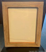 Front view of a rectangular wooden picture frame with natural wood finish, suitable for 11x14 inch photos.