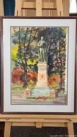Full view of framed watercolor painting depicting the statue of Sir John A with trees in background.
