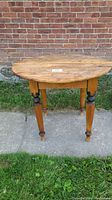 Front view of the round pine tavern table showing full profile and turned legs