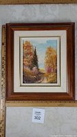 Framed oil painting on masonite of fall landscape with frame and measuring rulers for scale