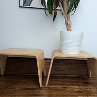 Two IKEA FOLKESTORP wooden stools with a plant pot on one, showing the overall shape and size against wall and floor.