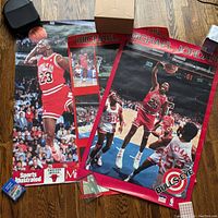 Three Michael Jordan Chicago Bulls posters stacked showing distinct images of him playing basketball.