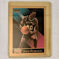 Front of 1990 Skybox David Robinson rookie card showing action photo in Spurs uniform and branding.