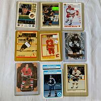 Full set of 10 hockey cards laid out on white fabric, including rookie cards of Pavel Bure, Sergei Fedorov, Mark Recchi, Gary Suter, Evgeni Malkin, Brett Hull, and Borje Salming.