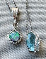 Close-up of the opal and tourmaline pendants showing details of the stones and silver settings.