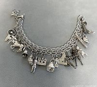 Front view of double chain sterling silver charm bracelet with assorted charms