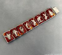 Full view of the vintage sterling silver and red enamel bracelet showing linked panels with silver inlay designs of Thai figures.
