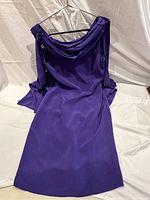 Front view of purple Albert Nipon cocktail dress showing draped neckline and long flowing sleeves