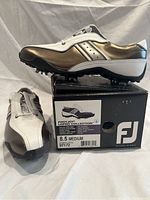 Side view of one FootJoy LoPro Collection golf shoe size 8.5 medium on original box