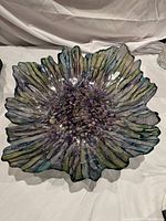 Front view of the decorative glass table bowl showing multi-colored iridescent flower petal design