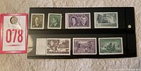 Set of seven Canadian mint stamps from the 1950s on black card