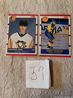 Front side of Jaromir Jagr and Mats Sundin rookie hockey cards from 1990-91 Score series with a note showing number 39.