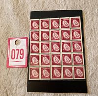Full view of a 25-stamp pane mounted on black card, showing red Christmas praying hands stamps, each valued at 3 cents with 'Christmas - Noël' text. Includes a red and white lot number card '079' placed beside it for scale.