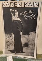 Front view of black and white poster showing Karen Kain with hand raised, signed with personal inscription.