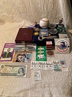 Full overview of assorted keepsakes including coins, baseball memorabilia, medallions, pens, tickets, and collectibles