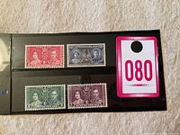 Four mint Newfoundland stamps from 1937 Royal Visit arranged on black card with a lot number tag