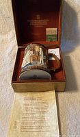 Tankard mug inside original maroon velvet-lined box. Includes original Eaton's store label and certificate of authenticity showing details about the 1974 Christmas Carol edition.