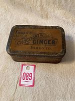 Angle view showing full metal tin box with label and wear on edges.