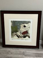 Framed limited edition print "Amsterdam NL" by Mark Raven in dark wood frame with white mat and non-reflective glass, showing abstract cityscape artwork.