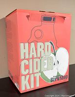 Front of the Brooklyn BrewShop Hard Cider Kit box showing the product name and illustration of a fermentation jug with apples.