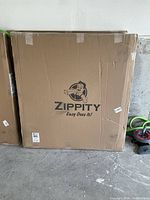 Cardboard box with Zippity logo and "Easy Does It!" slogan