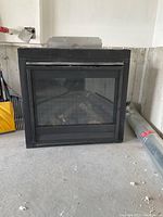 Black Hearth & Home Technologies DV3732-B gas fireplace unit with glass front and black metal frame