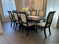 Full view of table with eight chairs arranged around