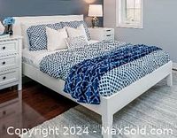 Full (Double) bed frame shown assembled in a decorated bedroom with bedding and pillows. Solid wood veneer with a white finish, clean modern design with rectangular headboard and footboard.