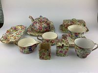 Full display of all tea set items showing floral pattern and condition.