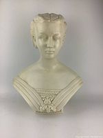 Front view of entire bust showing facial features and draped bodice.